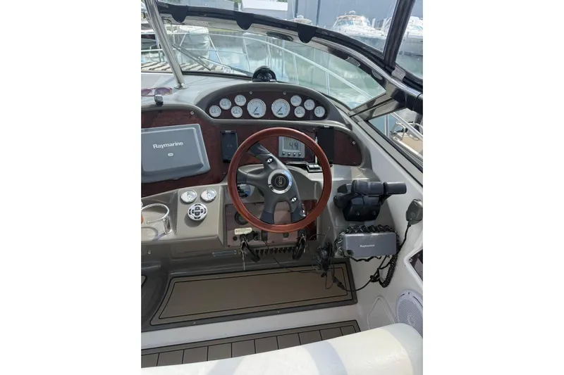 Borabora III Yacht Photos Pics 2007 Regal Commodore 3760 IB helm with Raymarine navigation system and wooden steering wheel.