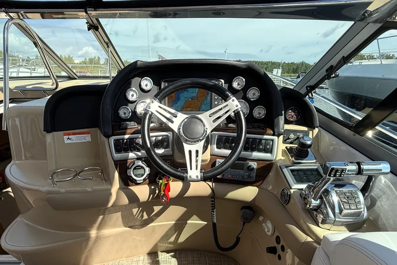  Yacht Photos Pics Cockpit of 2013 Four Winns Vista 375 boat with steering wheel and control panel.