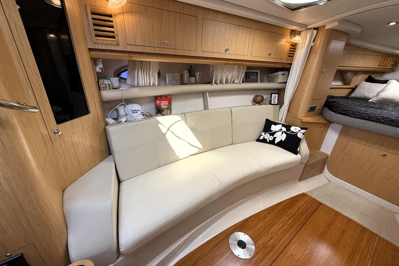  Yacht Photos Pics Luxurious interior of 2013 Four Winns Vista 375 yacht with elegant seating and wooden cabinetry.