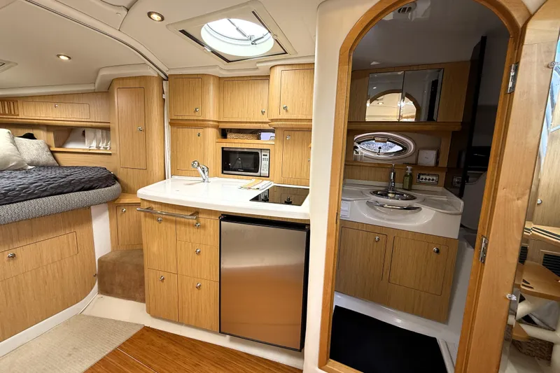  Yacht Photos Pics Luxurious 2013 Four Winns Vista 375 yacht interior with kitchenette and bathroom.