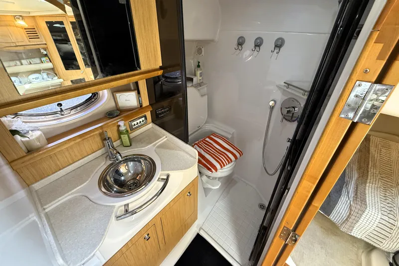  Yacht Photos Pics 2013 Four Winns Vista 375 bathroom with sink, shower, and wooden cabinetry.