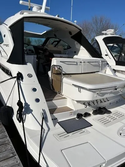  Yacht Photos Pics 2014 Sea Ray 410 Sundancer yacht docked, featuring spacious deck and seating area.
