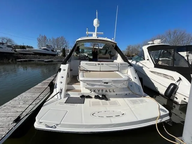 Yacht Photos Pics 2014 Sea Ray 410 Sundancer yacht docked, rear view with "Skyfall" name, clear blue sky.