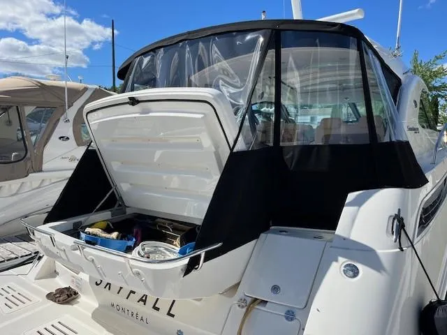  Yacht Photos Pics 2014 Sea Ray 410 Sundancer yacht with open storage compartment, docked under clear blue sky.