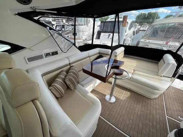  Yacht Photos Pics Luxurious interior of 2014 Sea Ray 410 Sundancer yacht with plush seating and wooden table.