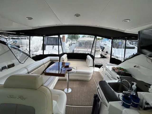  Yacht Photos Pics Interior of 2014 Sea Ray 410 Sundancer yacht with seating, table, and kitchenette.