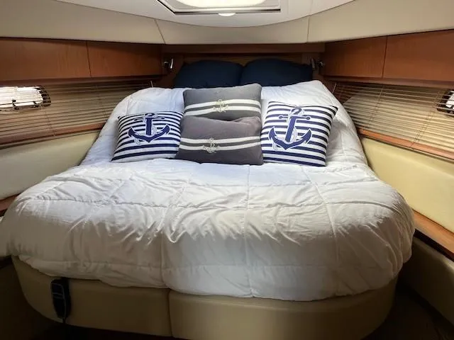  Yacht Photos Pics Luxurious cabin interior of 2014 Sea Ray 410 Sundancer with nautical-themed bedding.
