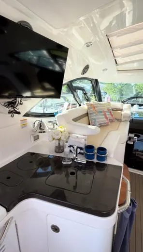  Yacht Photos Pics Interior of 2014 Sea Ray 410 Sundancer with TV, seating, and kitchenette.