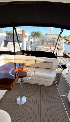  Yacht Photos Pics 2014 Sea Ray 410 Sundancer yacht interior with seating and table, docked at marina.