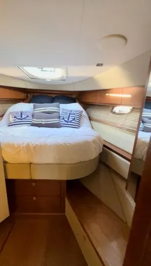  Yacht Photos Pics 2014 Sea Ray 410 Sundancer cabin with cozy bed and nautical-themed pillows.