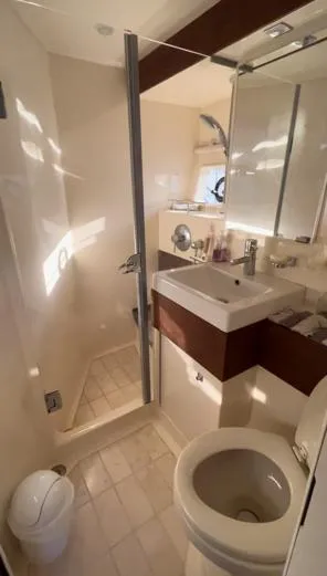  Yacht Photos Pics Bathroom interior of 2014 Sea Ray 410 Sundancer yacht, featuring shower, sink, and toilet.