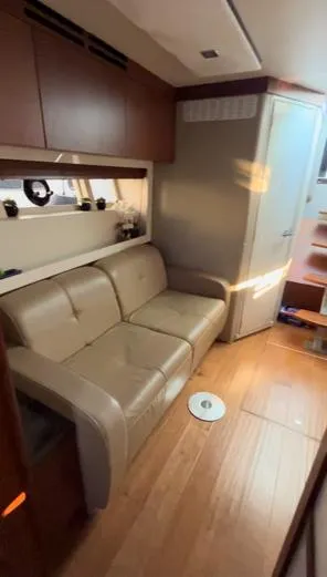  Yacht Photos Pics Interior of 2014 Sea Ray 410 Sundancer yacht with beige leather seating and wooden flooring.