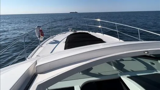  Yacht Photos Pics 2014 Sea Ray 410 Sundancer cruising on open water under clear skies.