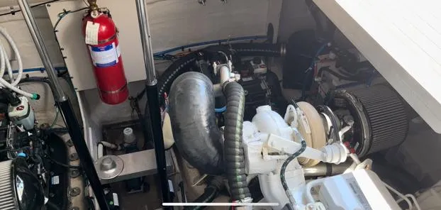  Yacht Photos Pics Engine compartment of 2014 Sea Ray 410 Sundancer with visible fire extinguisher and mechanical components.