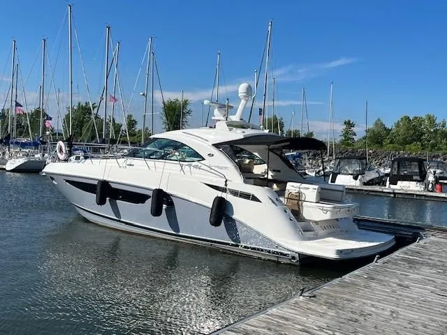  Yacht Photos Pics 2014 Sea Ray 410 Sundancer yacht docked at marina with sailboats in background.