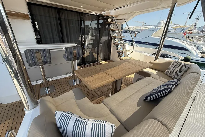 M/y Bishwish Yacht Photos Pics Luxurious 2018 Sunseeker Manhattan 66 yacht deck with seating and bar area.