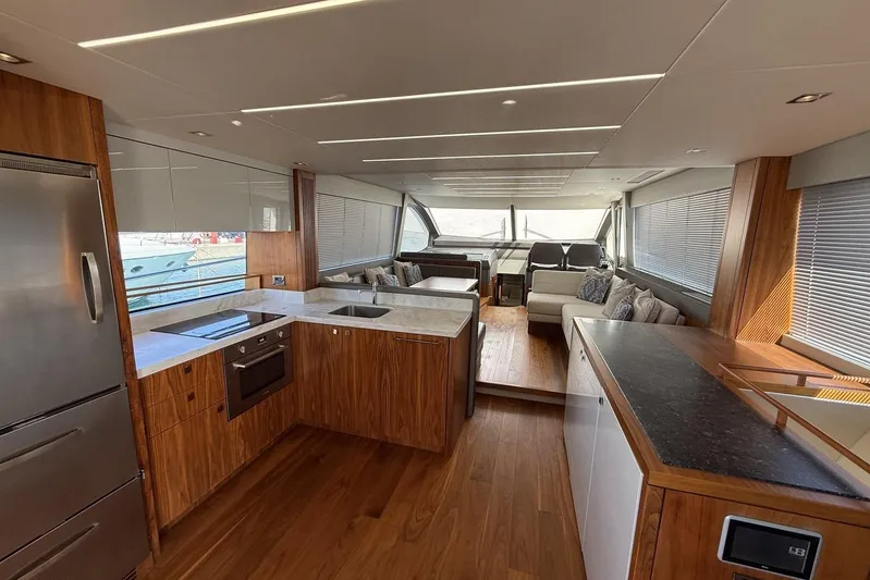 M/y Bishwish Yacht Photos Pics Luxurious interior of 2018 Sunseeker Manhattan 66 yacht with modern kitchen and seating area.