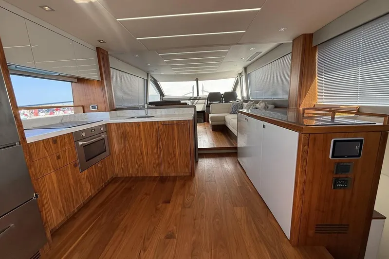 M/y Bishwish Yacht Photos Pics Luxurious interior of 2018 Sunseeker Manhattan 66 yacht with modern kitchen and seating area.