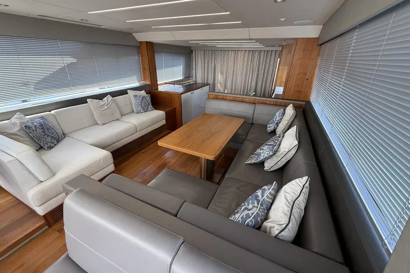 M/y Bishwish Yacht Photos Pics Luxurious interior of 2018 Sunseeker Manhattan 66 yacht with elegant seating and wooden table.