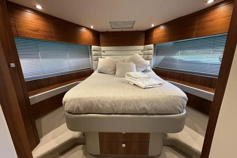 M/y Bishwish Yacht Photos Pics Luxurious bedroom interior of 2018 Sunseeker Manhattan 66 yacht with elegant wood paneling.