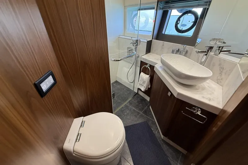 M/y Bishwish Yacht Photos Pics Luxurious bathroom in 2018 Sunseeker Manhattan 66 yacht with modern fixtures and elegant design.