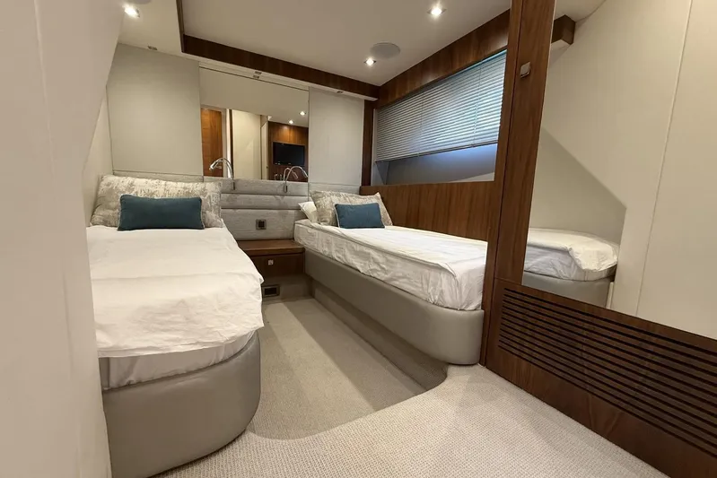 M/y Bishwish Yacht Photos Pics Luxurious twin bedroom in 2018 Sunseeker Manhattan 66 yacht, featuring modern design and cozy ambiance.