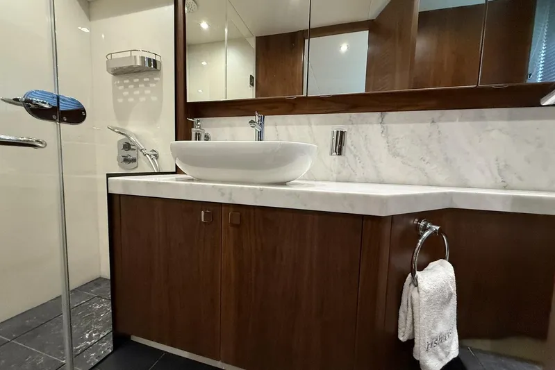 M/y Bishwish Yacht Photos Pics Luxurious bathroom in 2018 Sunseeker Manhattan 66 yacht with marble countertop and modern fixtures.