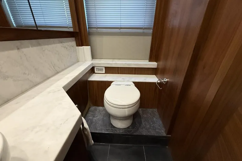 M/y Bishwish Yacht Photos Pics Luxurious bathroom in 2018 Sunseeker Manhattan 66 yacht with marble accents and wooden finishes.