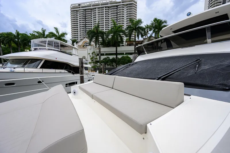 Harbour Time Yacht Photos Pics Astondoa 52 yacht, 2021 model, docked with modern buildings and palm trees in the background.
