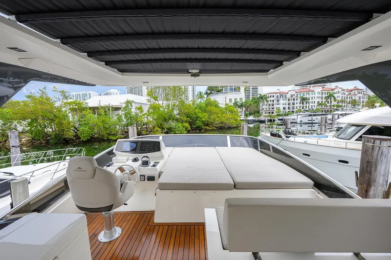 Harbour Time Yacht Photos Pics Luxurious 2021 Astondoa 52 yacht with spacious deck and modern seating in a marina setting.