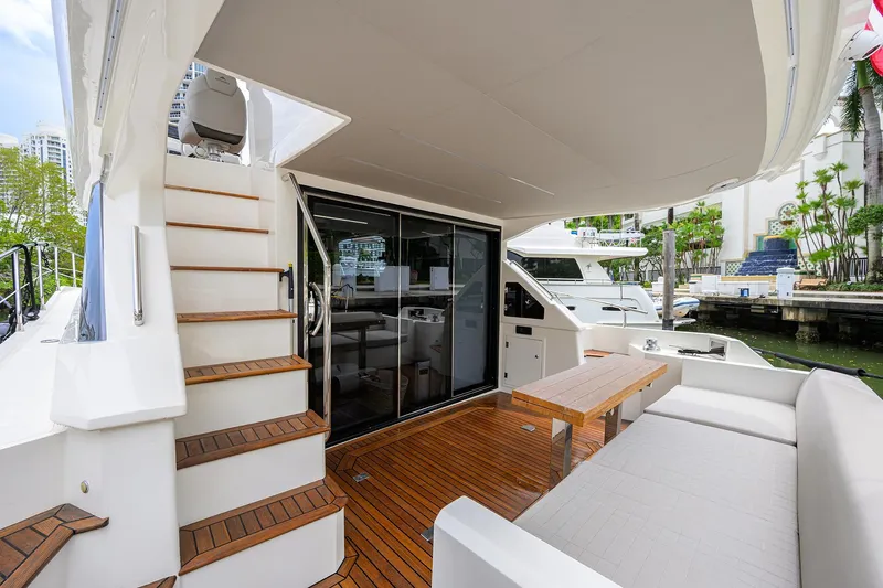 Harbour Time Yacht Photos Pics Astondoa 52 yacht 2021 model, featuring elegant outdoor seating and wooden deck.