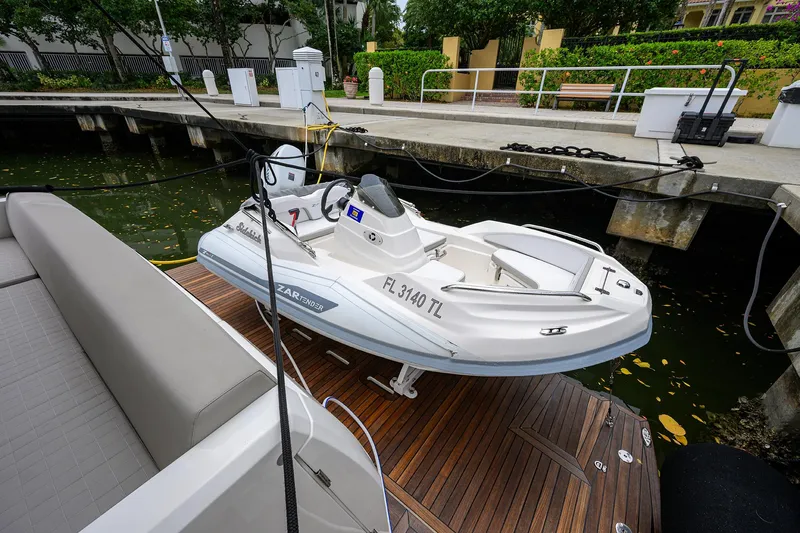 Harbour Time Yacht Photos Pics 2021 Astondoa 52 yacht with a small tender docked at a marina.