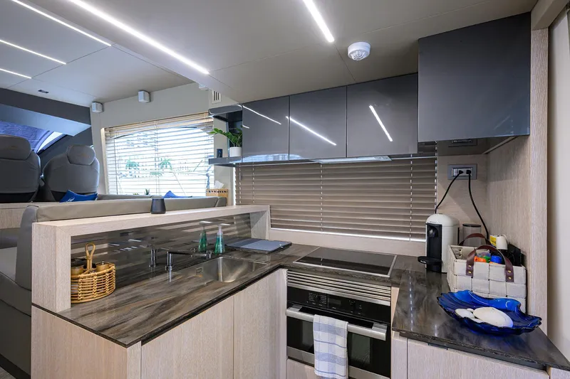 Harbour Time Yacht Photos Pics Modern kitchen interior of 2021 Astondoa 52 yacht with sleek cabinetry and appliances.