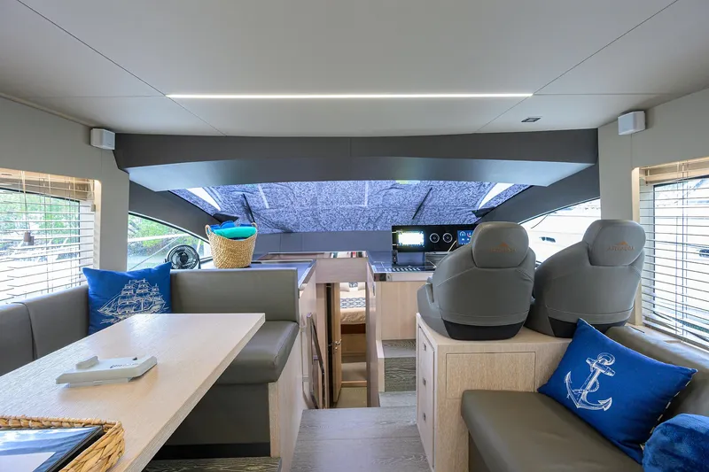 Harbour Time Yacht Photos Pics Interior of 2021 Astondoa 52 yacht with modern seating and helm, featuring nautical decor.
