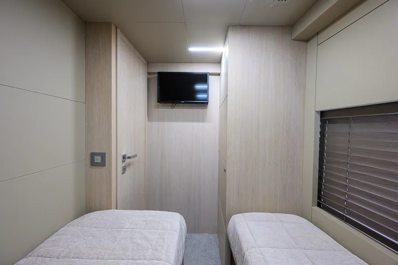 Harbour Time Yacht Photos Pics Interior of 2021 Astondoa 52 yacht cabin with twin beds and wall-mounted TV.