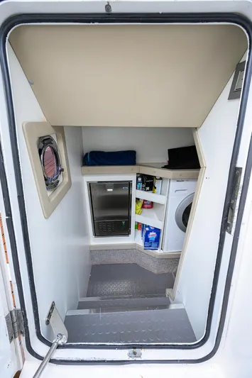 Harbour Time Yacht Photos Pics Interior view of 2021 Astondoa 52 yacht, featuring storage shelves and appliances.