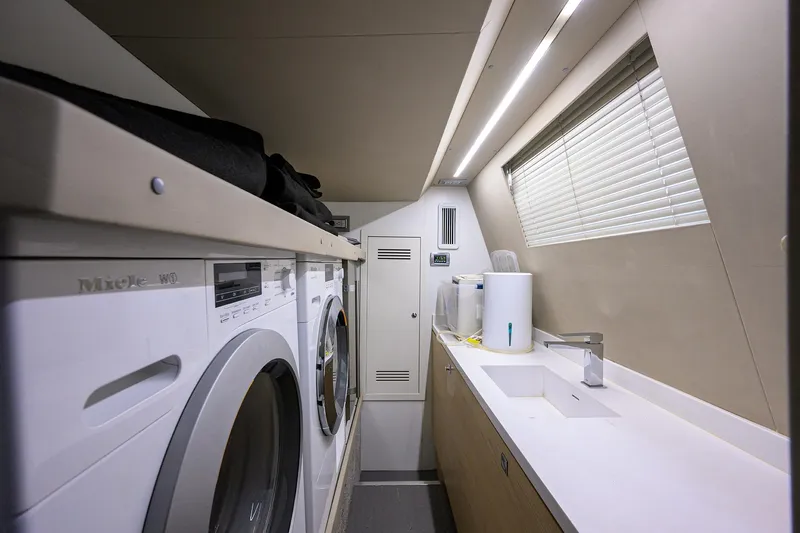Harbour Time Yacht Photos Pics Laundry room in 2021 Astondoa 52 yacht with washer, dryer, and sink.