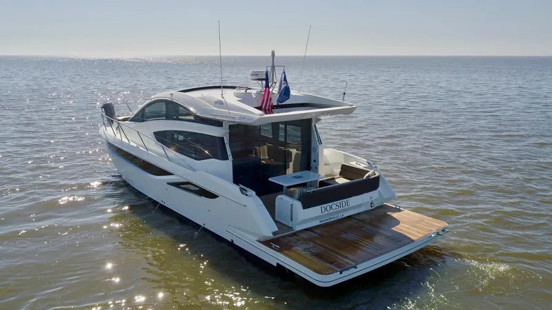 Docside Yacht Photos Pics 2021 Galeon 430 HTC yacht cruising on open water, rear view.