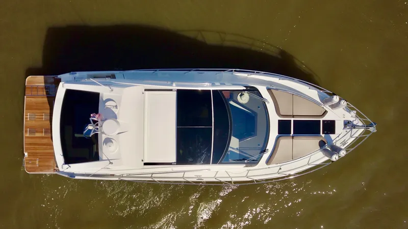 Docside Yacht Photos Pics Aerial view of 2021 Galeon 430 HTC yacht on calm water.