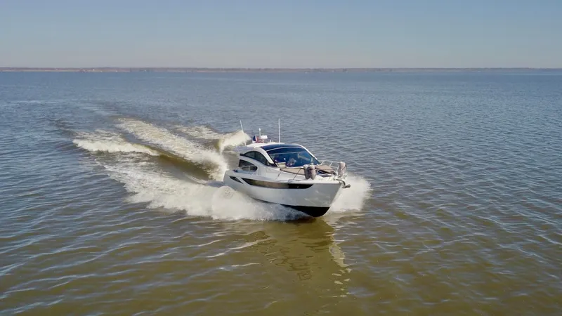 Docside Yacht Photos Pics 2021 Galeon 430 HTC yacht cruising on open water under clear skies.