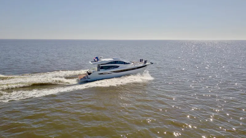 Docside Yacht Photos Pics 2021 Galeon 430 HTC yacht cruising on open water under clear skies.