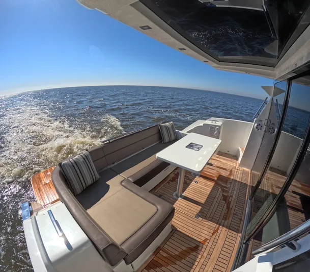 Docside Yacht Photos Pics 2021 Galeon 430 HTC yacht deck with seating, table, and ocean view.