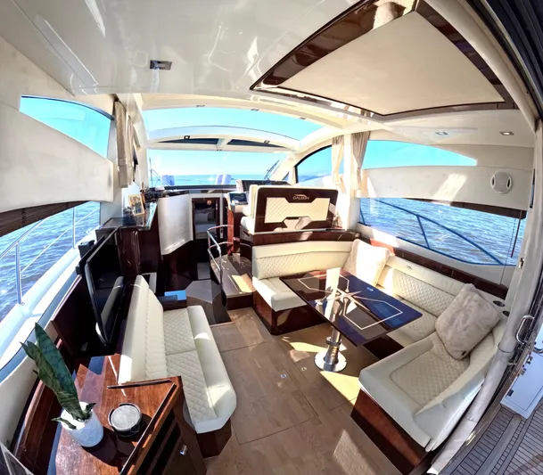 Docside Yacht Photos Pics Luxurious interior of 2021 Galeon 430 HTC yacht with elegant seating and panoramic windows.