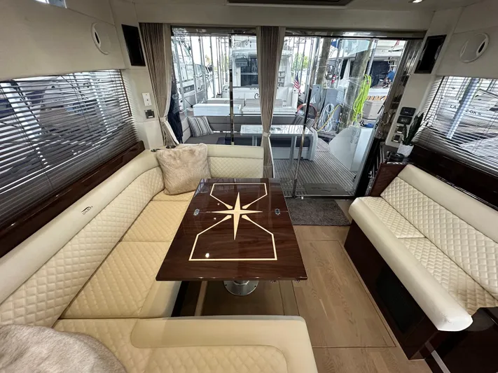 Docside Yacht Photos Pics Luxurious interior of 2021 Galeon 430 HTC yacht with elegant seating and wooden table.