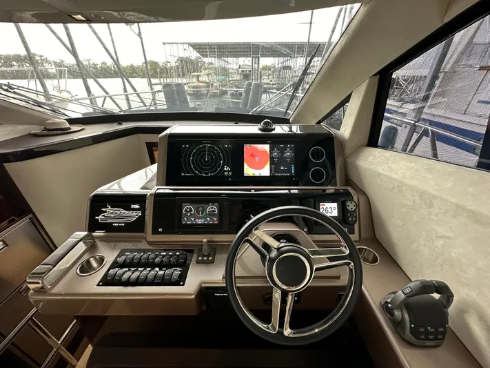 Docside Yacht Photos Pics Cockpit of 2021 Galeon 430 HTC yacht with modern navigation system and steering wheel.