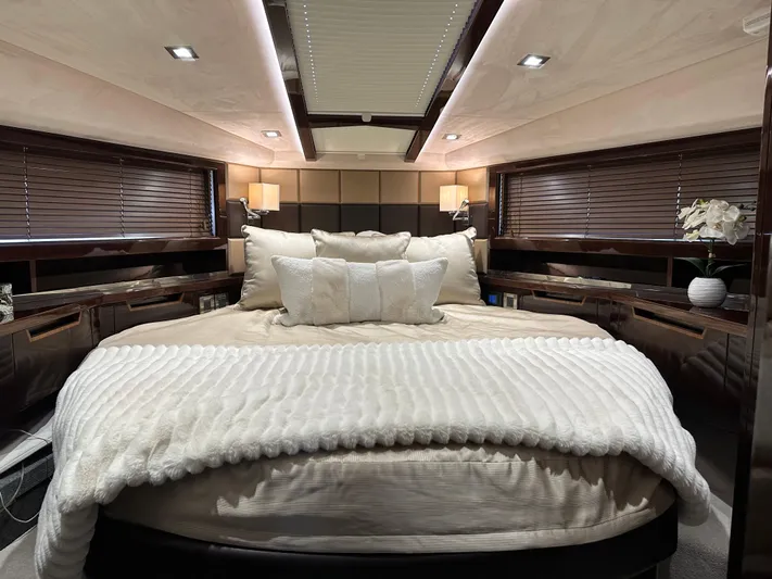 Docside Yacht Photos Pics Luxurious bedroom interior of 2021 Galeon 430 HTC yacht with elegant bedding and ambient lighting.