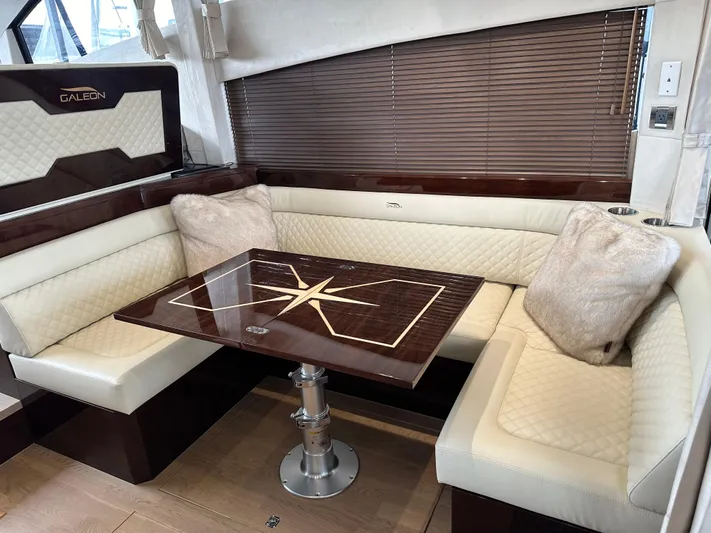 Docside Yacht Photos Pics Luxurious interior of 2021 Galeon 430 HTC yacht with elegant seating and wooden table.