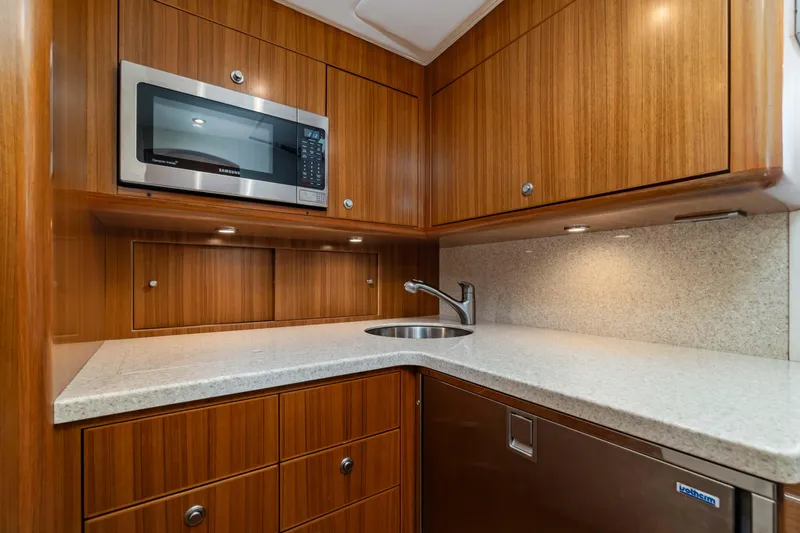 Fin Planner II Yacht Photos Pics Modern kitchen in 2021 Viking 38 Billfish yacht with wood cabinetry and microwave.