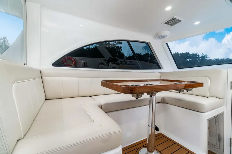 Fin Planner II Yacht Photos Pics Luxurious interior of 2021 Viking 38 Billfish yacht with elegant seating and wooden table.