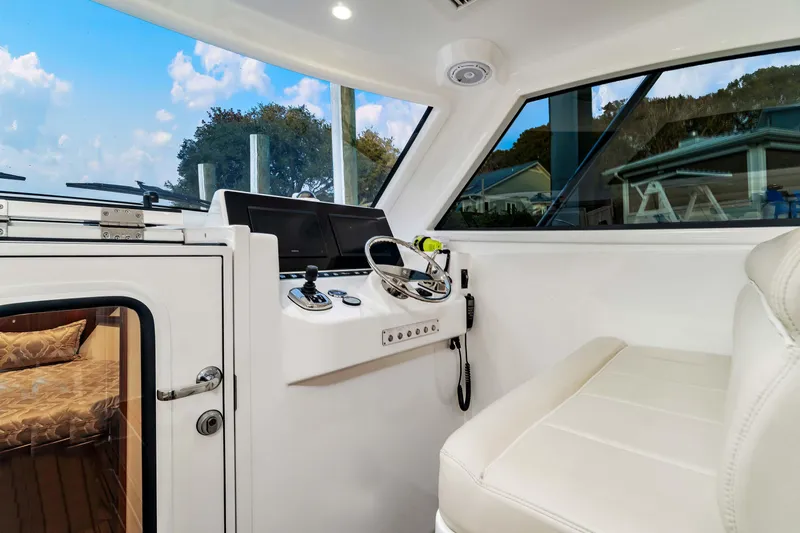 Fin Planner II Yacht Photos Pics Interior of 2021 Viking 38 Billfish boat with helm and seating area.